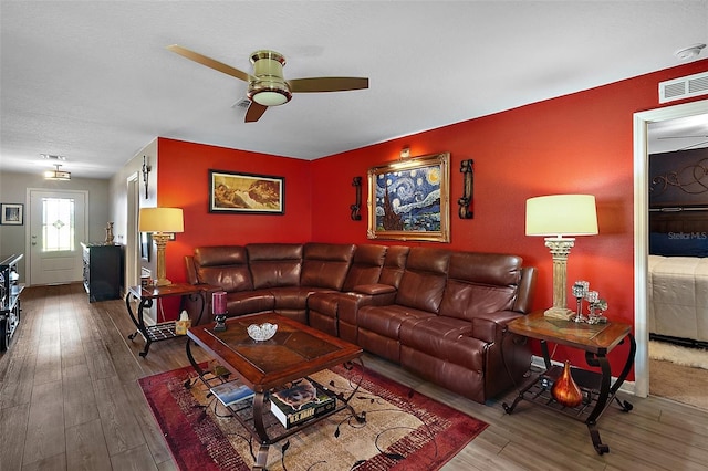 12952 Del Lago Dr, Astatula, FL 34705 - living area with ceiling fan, wood finished floors, and baseboards