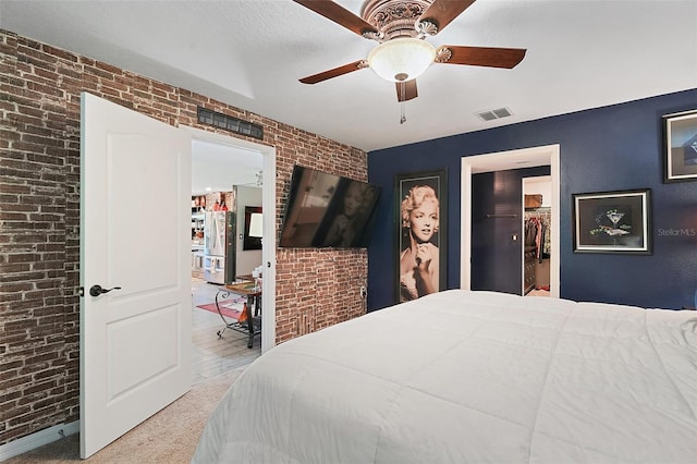 12952 Del Lago Dr, Astatula, FL 34705 - bedroom featuring brick wall, a walk in closet, carpet, ceiling fan, and a closet