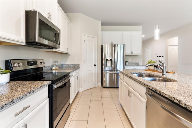 17112 Goldcrest Loop, Clermont, FL 34714 - kitchen featuring stainless steel appliances, white cabinetry, light stone counters, and light tile patterned floors