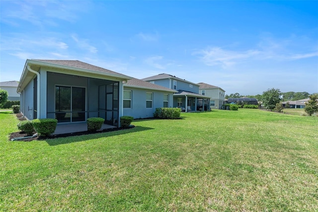 17112 Goldcrest Loop, Clermont, FL 34714 - rear view of house with a lawn, stucco siding, and a sunroom