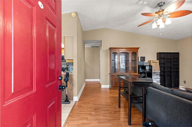 43 Almond Pass Dr, Ocala, FL 34472 - entryway with lofted ceiling, a ceiling fan, light wood-style floors, baseboards, and a textured ceiling
