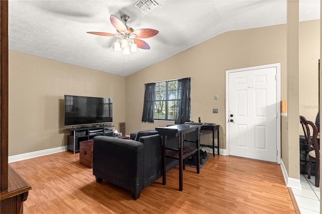 43 Almond Pass Dr, Ocala, FL 34472 - living room with vaulted ceiling, ceiling fan, light wood-type flooring, baseboards, and a textured ceiling