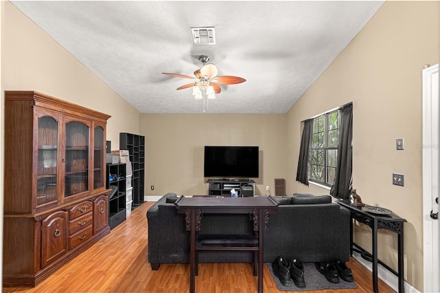 43 Almond Pass Dr, Ocala, FL 34472 - living room with ceiling fan, light wood finished floors, a textured ceiling, and vaulted ceiling