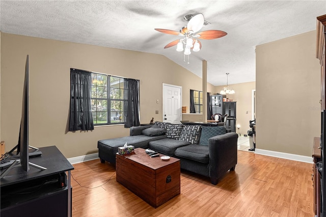 43 Almond Pass Dr, Ocala, FL 34472 - living area with ceiling fan, vaulted ceiling, light wood-style floors, baseboards, and a chandelier