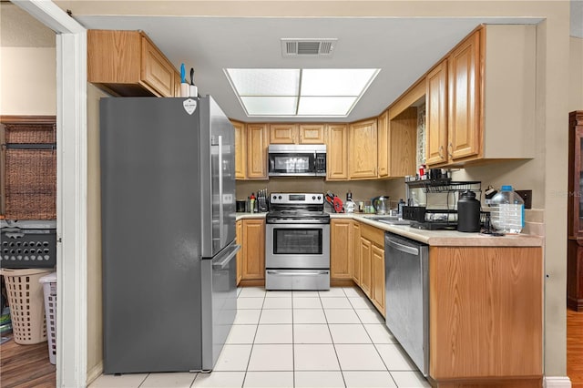 43 Almond Pass Dr, Ocala, FL 34472 - kitchen with appliances with stainless steel finishes, light countertops, light tile patterned floors, and a sink