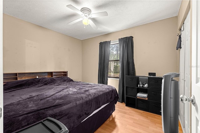 43 Almond Pass Dr, Ocala, FL 34472 - bedroom featuring wood finished floors, a textured ceiling, and a ceiling fan