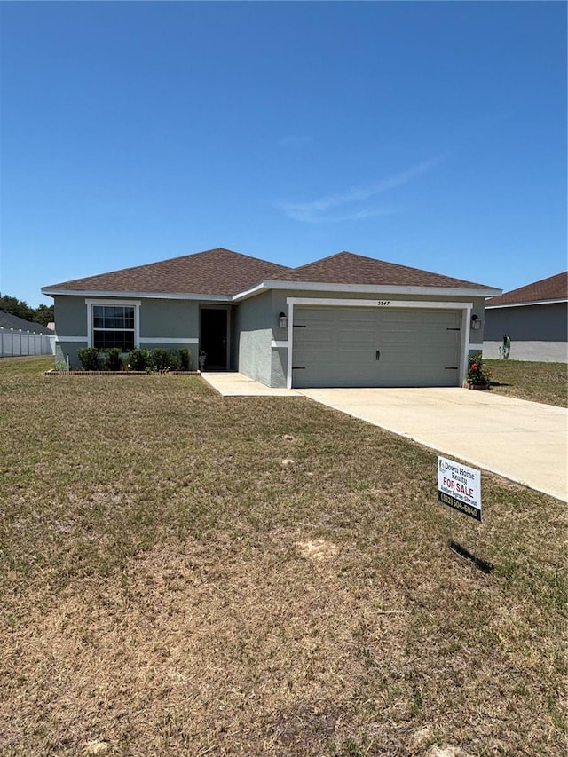 5547 SE 91st Pl, Ocala, FL 34480 - ranch-style house featuring a garage, driveway, a front lawn, and stucco siding