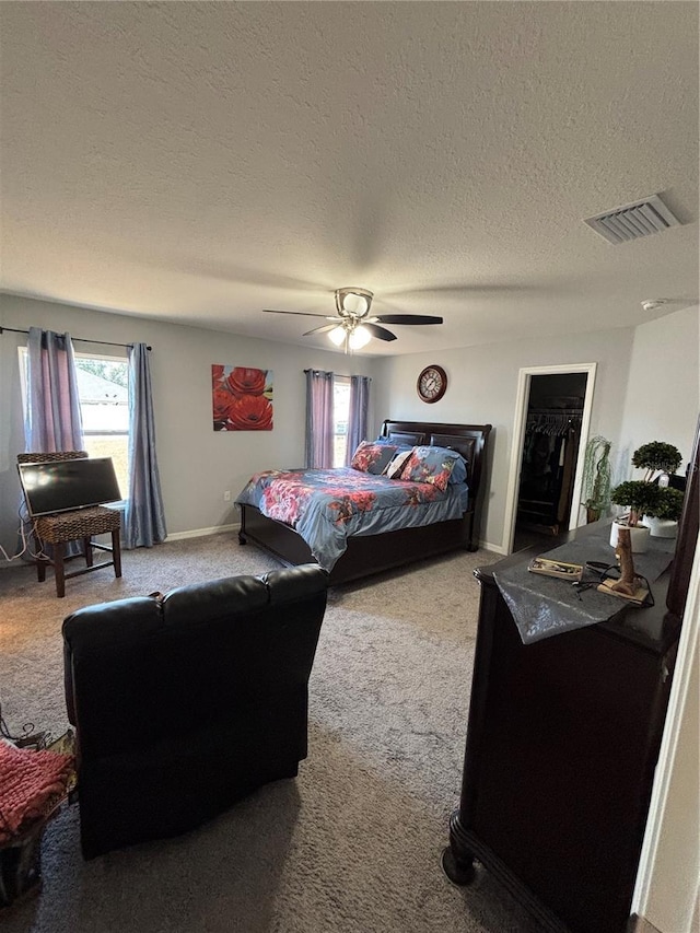 5547 SE 91st Pl, Ocala, FL 34480 - bedroom with carpet flooring, a textured ceiling, a spacious closet, ceiling fan, and baseboards