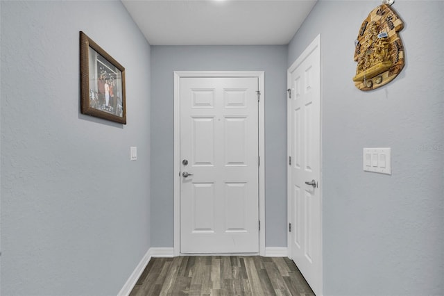 5547 SE 91st Pl, Ocala, FL 34480 - doorway with dark wood-type flooring and baseboards