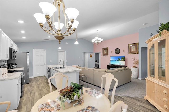 5547 SE 91st Pl, Ocala, FL 34480 - dining room with a chandelier, vaulted ceiling, light wood-style flooring, and recessed lighting