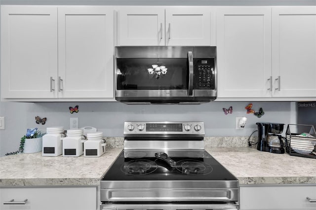 5547 SE 91st Pl, Ocala, FL 34480 - kitchen featuring stainless steel appliances, light countertops, and white cabinets