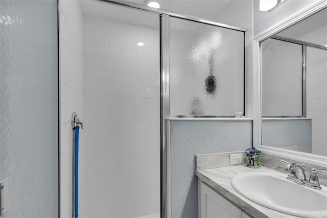5547 SE 91st Pl, Ocala, FL 34480 - bathroom featuring vanity, a shower stall, and a textured wall