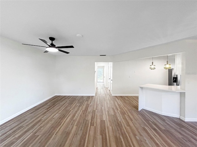 5136 Cedar Hammock Dr, Sarasota, FL 34232 - unfurnished living room with wood finished floors, baseboards, and ceiling fan
