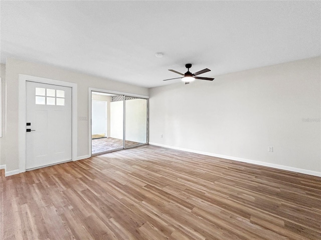 5136 Cedar Hammock Dr, Sarasota, FL 34232 - unfurnished living room with wood finished floors, ceiling fan, and baseboards