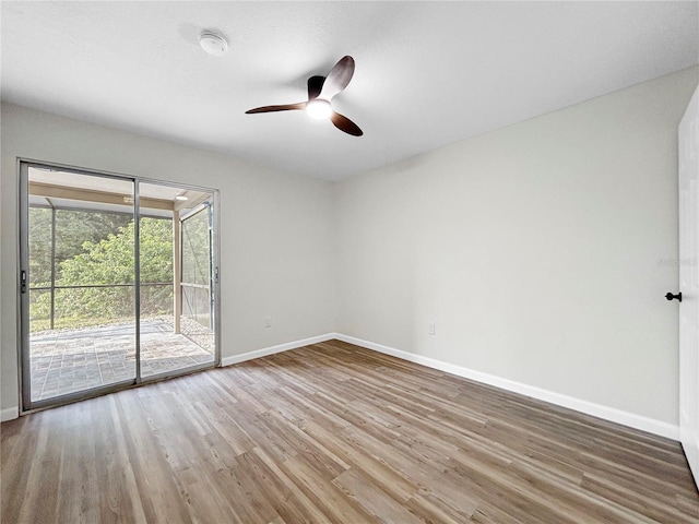 5136 Cedar Hammock Dr, Sarasota, FL 34232 - spare room with baseboards, wood finished floors, and a ceiling fan