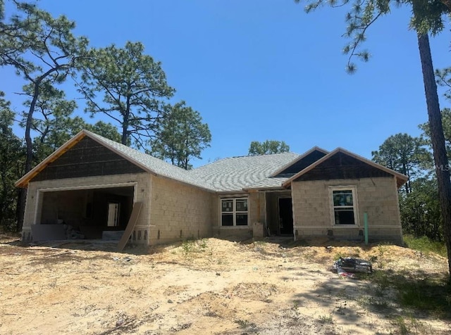 1816 W Hialeah Dr, Citrus Springs, FL 34434 - view of front of property with concrete block siding, an attached garage, and roof with shingles