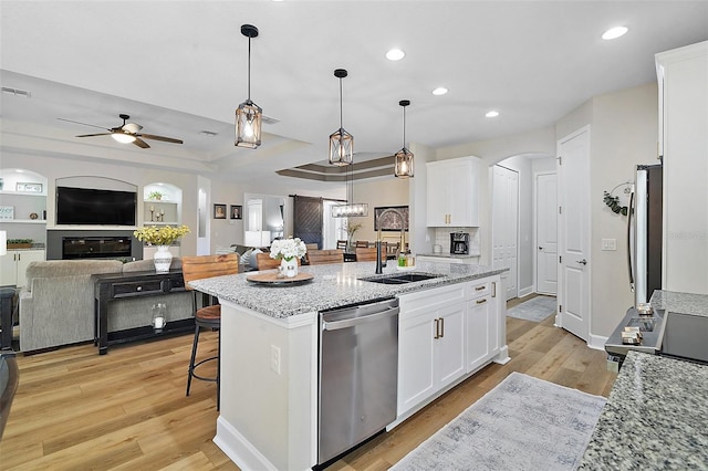 440 Bellissimo Pl, Howey In The Hills, FL 34737 - kitchen with stainless steel appliances, a sink, recessed lighting, a ceiling fan, and white cabinets