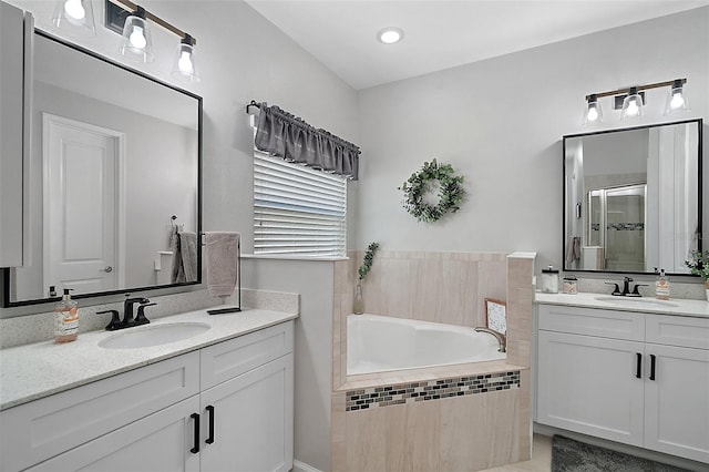 440 Bellissimo Pl, Howey In The Hills, FL 34737 - bathroom featuring two vanities, a stall shower, and a bath