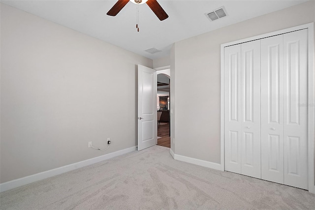 440 Bellissimo Pl, Howey In The Hills, FL 34737 - unfurnished bedroom with carpet, baseboards, a closet, arched walkways, and a ceiling fan