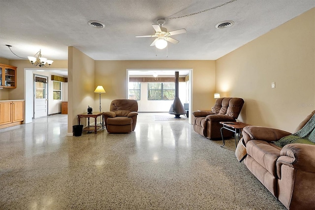 2007 Mosher Dr, Orlando, FL 32810 - living room with a ceiling fan, a chandelier, speckled floor, a textured ceiling, and baseboards