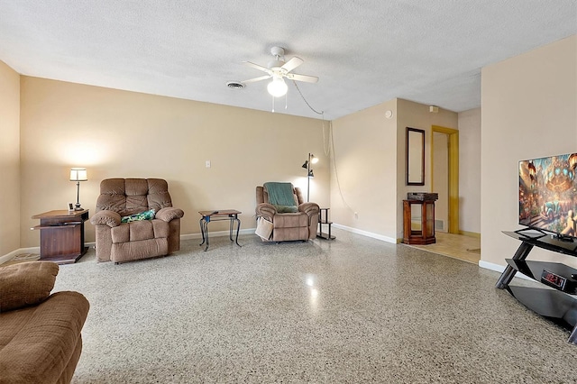 2007 Mosher Dr, Orlando, FL 32810 - sitting room with ceiling fan, speckle patterned floor, baseboards, and a textured ceiling