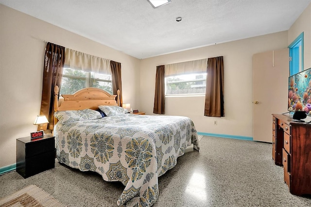 2007 Mosher Dr, Orlando, FL 32810 - bedroom with multiple windows, baseboards, and speckled floor