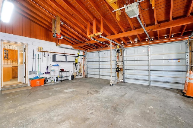 2007 Mosher Dr, Orlando, FL 32810 - garage featuring a garage door opener and concrete block wall