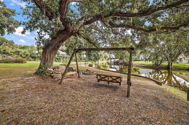 10303 SE Sunset Harbor Rd, Summerfield, FL 34491 - view of yard with a water view and a playground