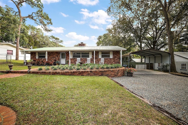 10303 SE Sunset Harbor Rd, Summerfield, FL 34491 - ranch-style home with a chimney, driveway, a detached carport, brick siding, and metal roof