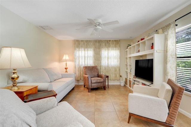 410 E Gulley Ave, Oakland, FL 34760 - living room with ceiling fan, light tile patterned floors, and baseboards