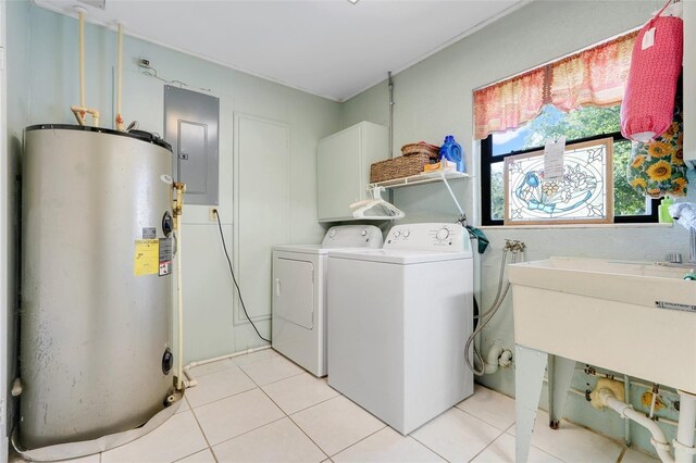 410 E Gulley Ave, Oakland, FL 34760 - laundry area with water heater, electric panel, washing machine and clothes dryer, and light tile patterned floors