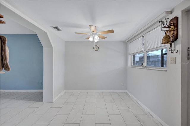 6443 34th Ave N, Saint Petersburg, FL 33710 - spare room with ceiling fan, baseboards, and arched walkways