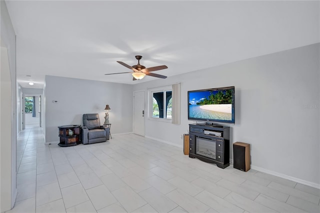 6443 34th Ave N, Saint Petersburg, FL 33710 - living room with healthy amount of natural light, ceiling fan, and baseboards
