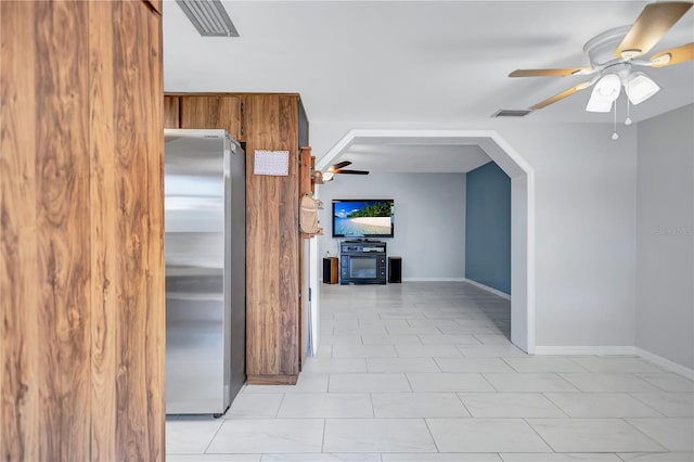 6443 34th Ave N, Saint Petersburg, FL 33710 - kitchen featuring freestanding refrigerator, a ceiling fan, brown cabinets, and baseboards