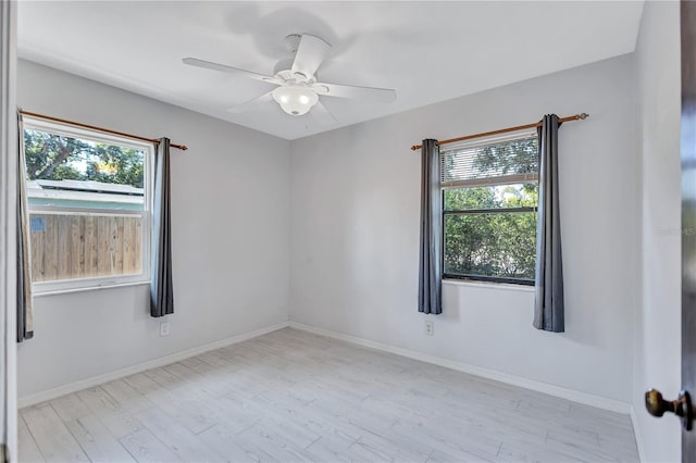 6443 34th Ave N, Saint Petersburg, FL 33710 - empty room featuring plenty of natural light, wood finished floors, and a ceiling fan