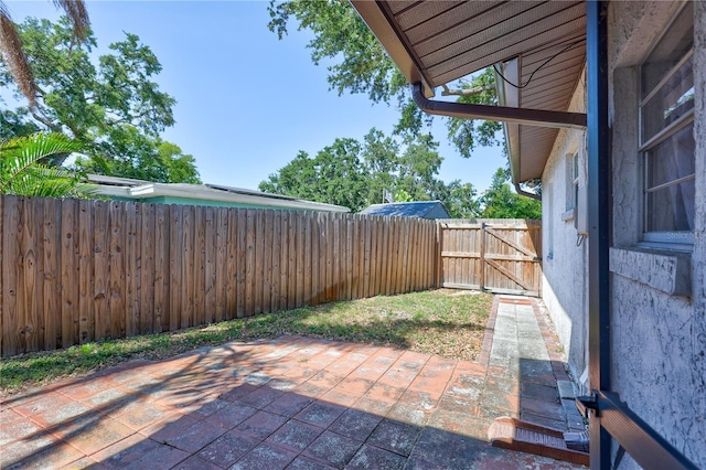 6443 34th Ave N, Saint Petersburg, FL 33710 - fenced backyard with a patio area and a gate