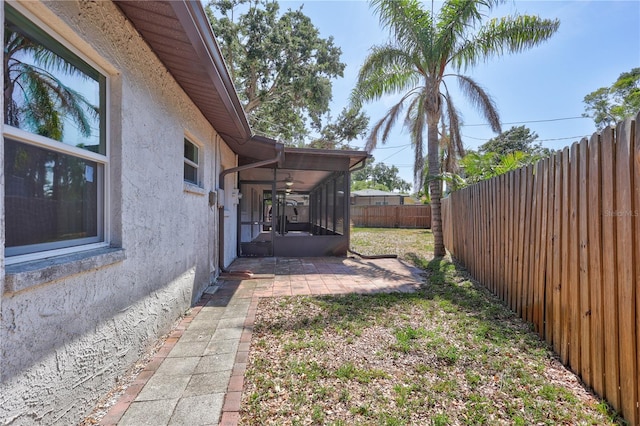 6443 34th Ave N, Saint Petersburg, FL 33710 - fenced backyard featuring a patio and a sunroom