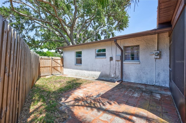 6443 34th Ave N, Saint Petersburg, FL 33710 - rear view of house with stucco siding, a patio area, and a fenced backyard