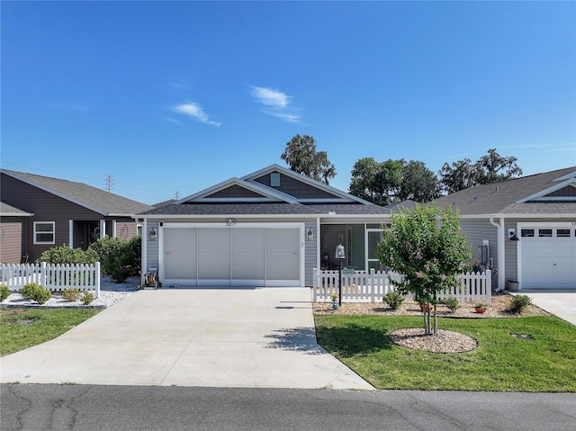 3817 Miragalia Ln, The Villages, FL 32163 - ranch-style house with driveway, an attached garage, and a shingled roof