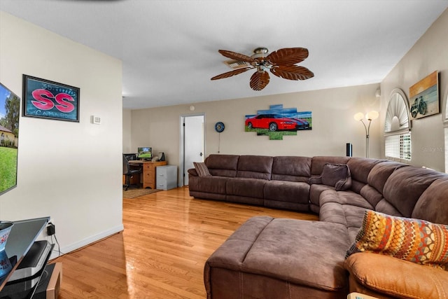 22 Palm Circle Dr, Inglis, FL 34449 - living room featuring a ceiling fan, light wood finished floors, a desk, and baseboards
