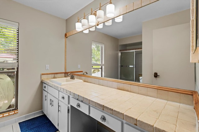 22 Palm Circle Dr, Inglis, FL 34449 - full bath featuring vanity, a shower stall, baseboards, and tile patterned floors