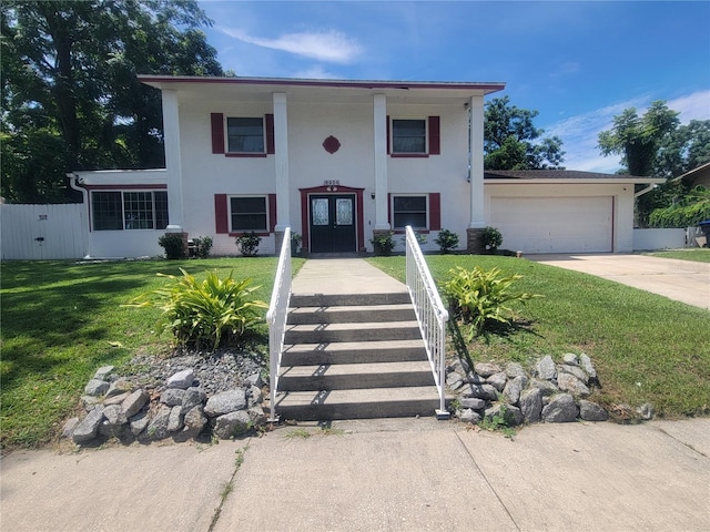 6924 Nawadaha Blvd, Orlando, FL 32818 - neoclassical / greek revival house featuring concrete driveway, stucco siding, an attached garage, and french doors