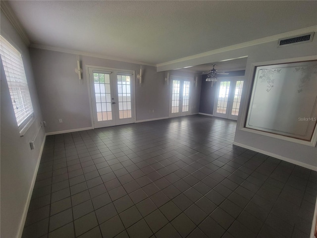6924 Nawadaha Blvd, Orlando, FL 32818 - spare room with crown molding, healthy amount of natural light, dark tile patterned flooring, french doors, and a ceiling fan