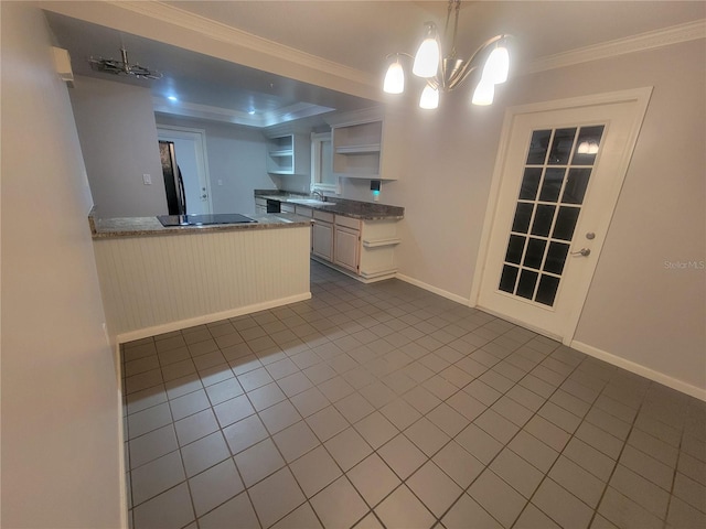 6924 Nawadaha Blvd, Orlando, FL 32818 - kitchen featuring open shelves, dark tile patterned floors, black electric cooktop, ornamental molding, and a peninsula