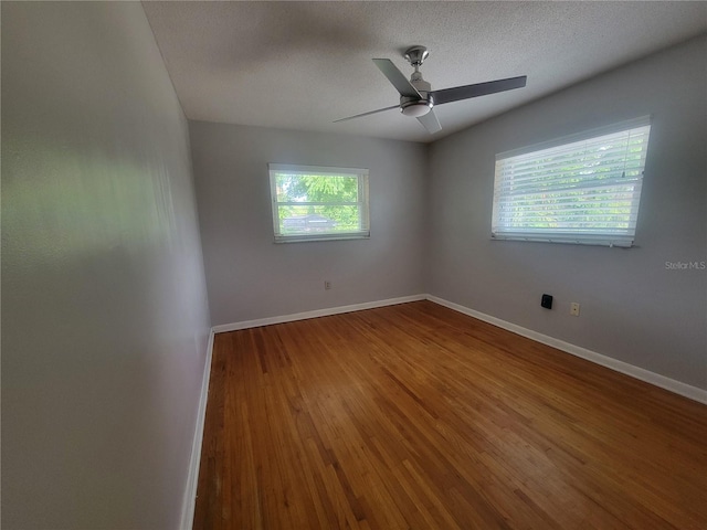 6924 Nawadaha Blvd, Orlando, FL 32818 - unfurnished room featuring plenty of natural light, wood finished floors, ceiling fan, and a textured ceiling