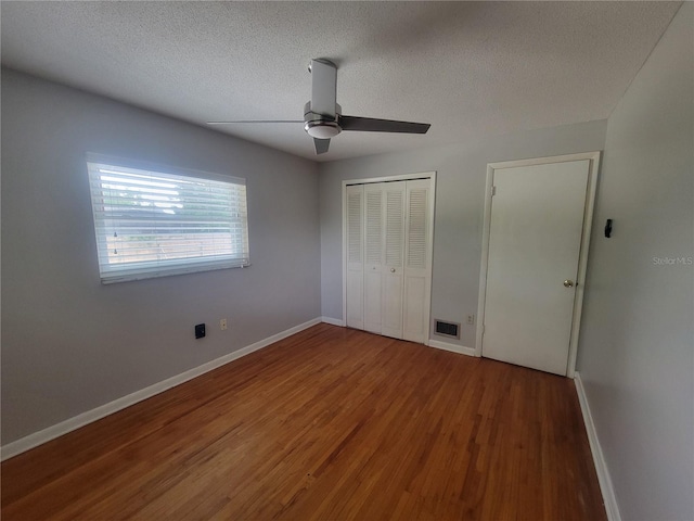 6924 Nawadaha Blvd, Orlando, FL 32818 - unfurnished bedroom with wood finished floors, a textured ceiling, a closet, and ceiling fan