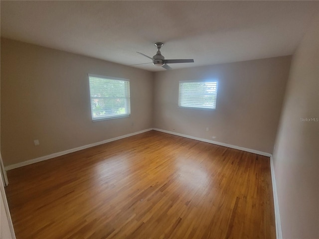 6924 Nawadaha Blvd, Orlando, FL 32818 - empty room with healthy amount of natural light, light wood-style floors, and ceiling fan