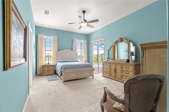 11215 SE 172nd Pl, Summerfield, FL 34491 - bedroom with access to outside, carpet flooring, multiple windows, a ceiling fan, and a textured wall