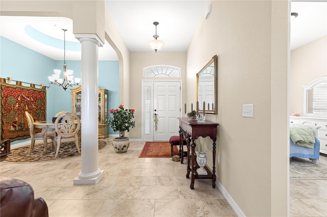 11215 SE 172nd Pl, Summerfield, FL 34491 - foyer entrance with decorative columns and a chandelier