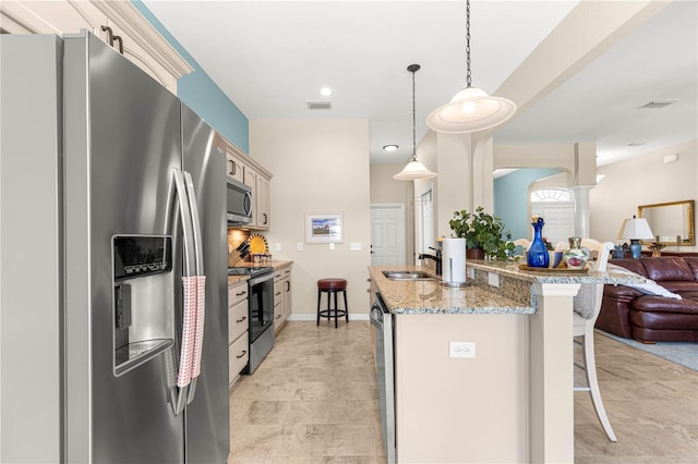11215 SE 172nd Pl, Summerfield, FL 34491 - kitchen featuring stainless steel appliances, open floor plan, a breakfast bar, pendant lighting, and light stone counters